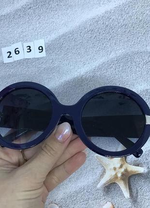 Круглые солнцезащитные очки черные в синей оправе5 фото