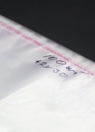 Пакети пп з клейкою стрічкою без друку 42х30см 25мкм 100шт/уп у закритому вигляді - 37,5х30см прозорі