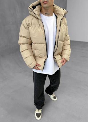 Оверсайз пуховик з капюшоном у бежевому кольорі