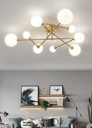 Стельова люстра в латунному корпусі з вигнутими ріжками на 9 ламп