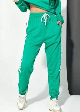 Зелені трикотажні штани з тасьмами
