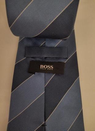 Шовкова краватка, бренду hugo boss у смужку, блакитно синього кольору1 фото