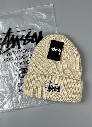 Жіноча бежева шапка stussy