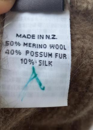 Теплая шапка от бренда koru из меха оппосума, мериноса м шелка