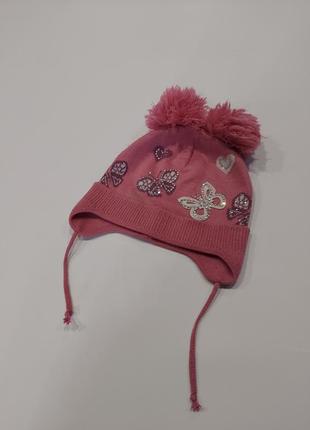 Демисезонная шапка с двумя бубонами в бабочки розовая 2-4 года