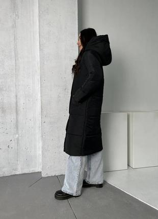 Длинная женская зимняя куртка с капюшоном.2 фото