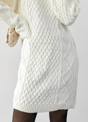 В'язана жіноча сукня-туніка з візерунками із косичок та ромбів.10 фото