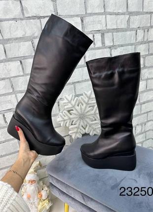 Високі зимові жіночі чоботи з натуральної шкіри на платформі8 фото