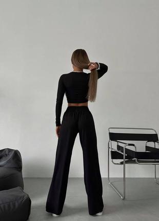 Костюм чорний топ з довгими рукавами та широкі штани4 фото