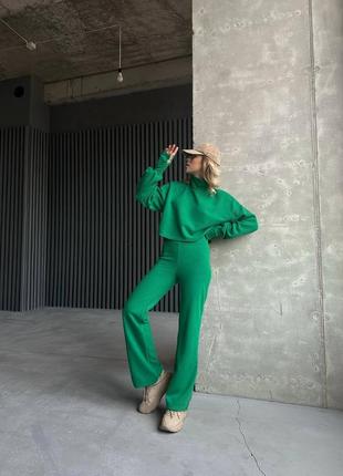 Женский теплый зеленый брючный костюм: укороченная кофта и широкие брюки трубы4 фото