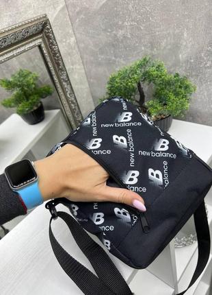 Маленька спортивна сумочка з одним відділенням, чорна тканинна2 фото