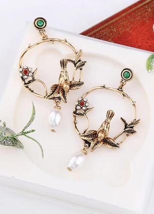 Жіночі сережки заокруглені у формі птиці та квітки декор камені перли колір золотистий7 фото