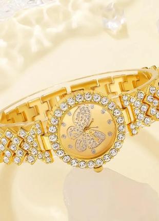 Розкішний годинник жіночий наручний кварцовий цвіт золотистий у каменях декор метелик у комплекті з сяйним5 фото