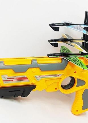 Детский игрушечный пистолет с самолетиками air battle катапульта с летающими самолетами (ab-1). цвет: желтый3 фото