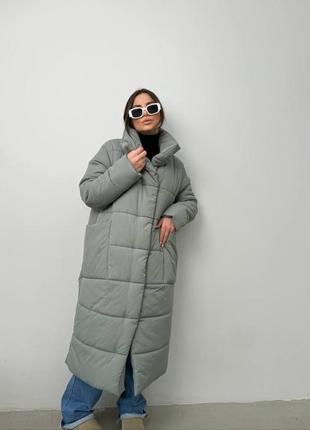 Теплая длинная дутая стеганая зимняя куртка на экопух, объемная куртка на зиму с глубокими карманами на кнопках7 фото