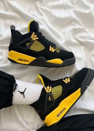 Класні кросівки nike air jordan 4 retro thunder чорні з жовтим унісекс 36-45 р