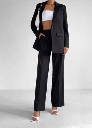 Стильный классический костюм с брюками дворца высокой посадкой карманами широкие брюки пиджак удлиненный свободного прямого кроя2 фото
