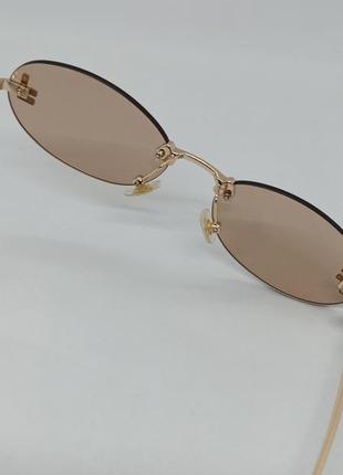 Окуляри в стилі fendi Teen жіночі сонцезахисні овальні бежеві безоправні з золотим логотипом5 фото