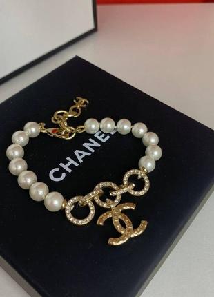 Шанеl браслет с жемчугом и кольцами с подвесным элементом-логотипом. декорирован цирноками