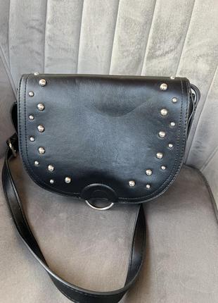 Черная сумка через плечо с металлическими клепками