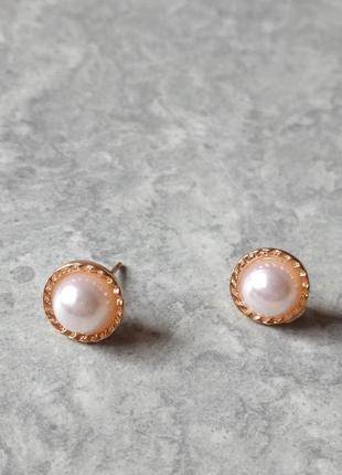 Красиві маленькі золотисті сережки з перлами.