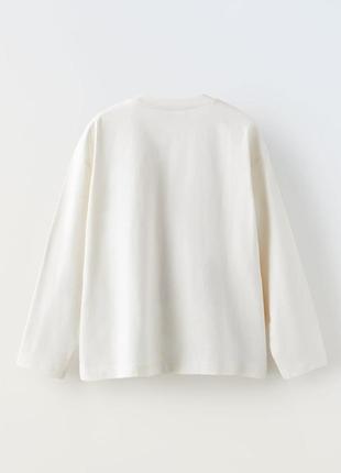 Zara 154 футболка з круглим вирізом довгий рукав. друк спереду.

бежевий2 фото