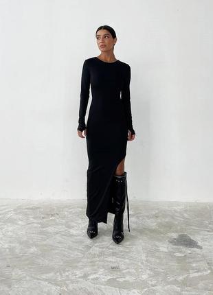 Стильне чорне жіноче плаття з розрізом збоку чорна сукня з розрізом збоку довге плаття асиметричне довга сукня асиметрична плаття міді сукня міді5 фото