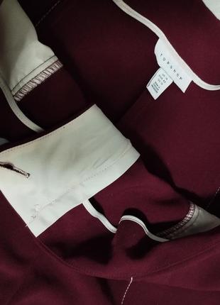 Широкие бордовые брюки с карманами и контрастной окантовкой6 фото