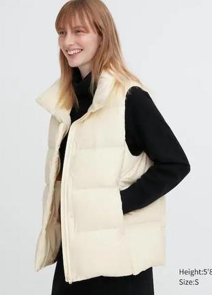 Пухова жилетка, безрукавка , молочного кольору японського бренду uniqlo