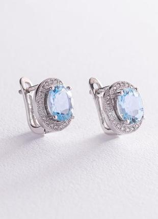 Срібні сережки з блакитними топазами 
і фіанітами 1213891 фото