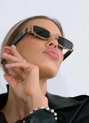 Солнцезащитные очки унисекс с кольцом modern черные с золотом1 фото
