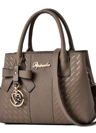Жіноча стильна шкіряна сумочка модного бренду сумочка з ремінцями брелок3 фото