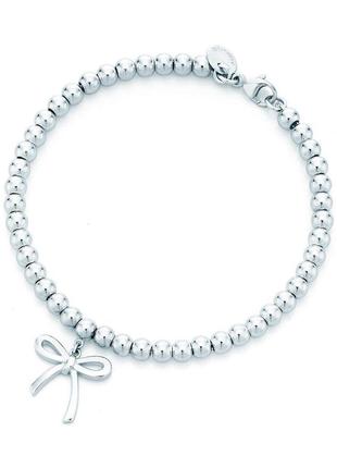 Элегантный серебряный браслет с бантом от tiffany & co: изысканное воплощение грации1 фото