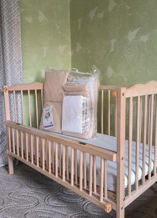 Ліжечко для новонароджених з механізмом заколисування та відкидним бортиком1 фото