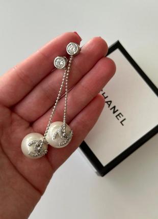 Брендові сережки срібного кольору з висячою перлиною та цирконами1 фото