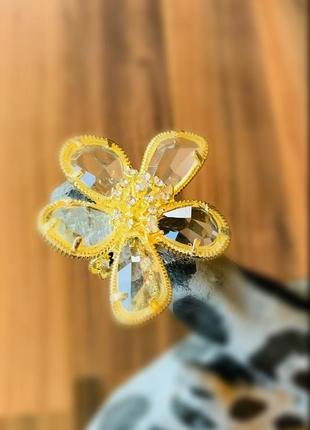 Кольцо с массивным цветком украшено кристаллами.2 фото