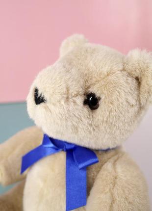 Мягкая игрушка медвежонок "althans club" с синей лентой.2 фото
