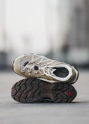 Чоловічі кросівки коричневі з білим salomon xt-quest4 фото