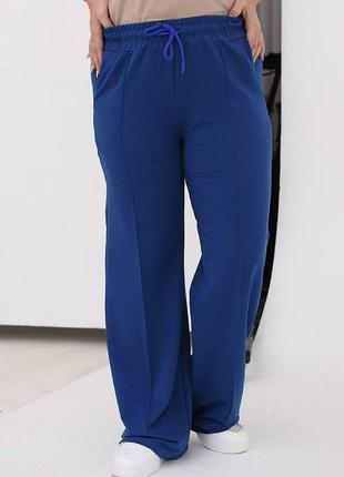 Жіночі весняні спортивні штани в стилі карго з двонитки з кишенями розміри 46-564 фото