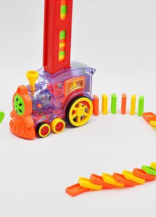 Игрушка паровозик строящий дорогу из домино domino train2 фото