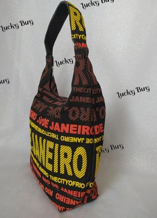 Жіноча текстильна чорна сумка з яскравими написами8 фото