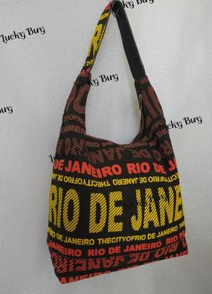 Жіноча текстильна чорна сумка з яскравими написами7 фото