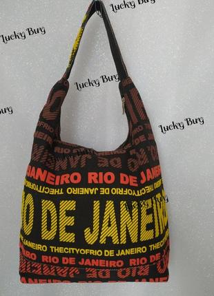 Жіноча текстильна чорна сумка з яскравими написами4 фото