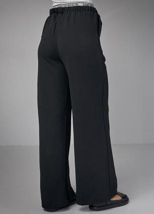 Женские черные штаны палаццо6 фото