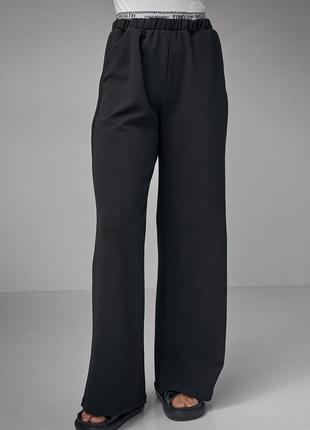 Женские черные штаны палаццо7 фото