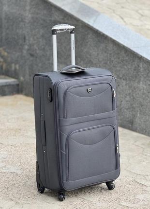 Середня валіза дорожня тканинна m польща на колесах wings з підшипником6 фото