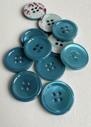 Пуговица 7/638 костюмная тонкая бортик 4отв голубая 17мм ракуш