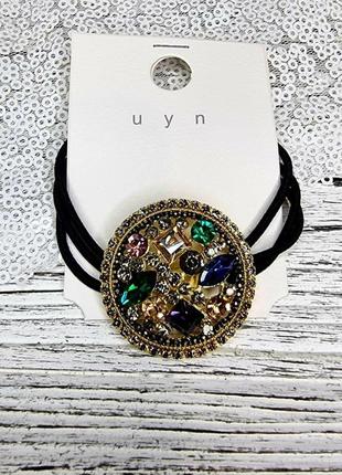 Гумка для волосся з круглим декором золотиста з камінчиками