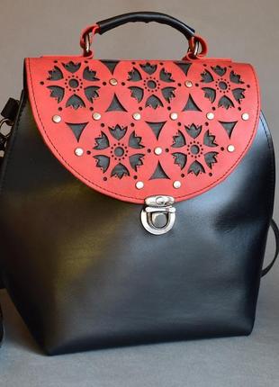 A wonderful compact leather bag with a unique ornament