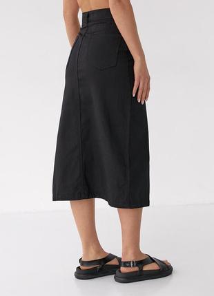 Женская черная асимметричная коттоновая юбка миди с полукруглым разрезом3 фото
